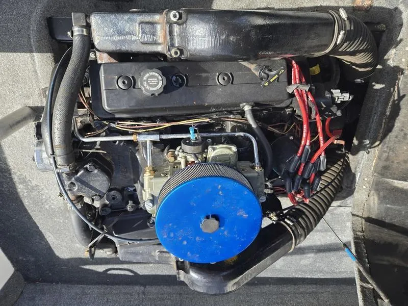 Slide: The Image of 2001 Malibu Sportster engine with blue air filter and red wiring, top view. - 19