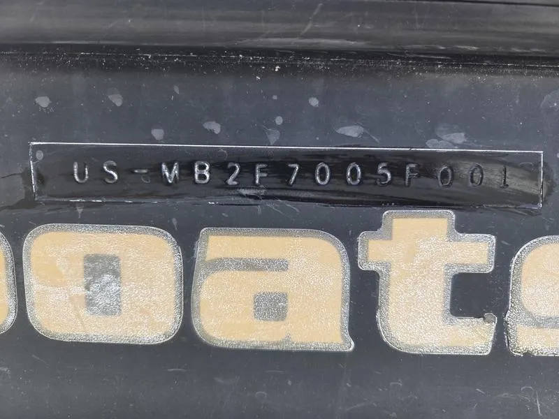 Slide: The Image of 2001 Malibu Sportster boat with visible hull identification number (HIN) on black surface. - 9