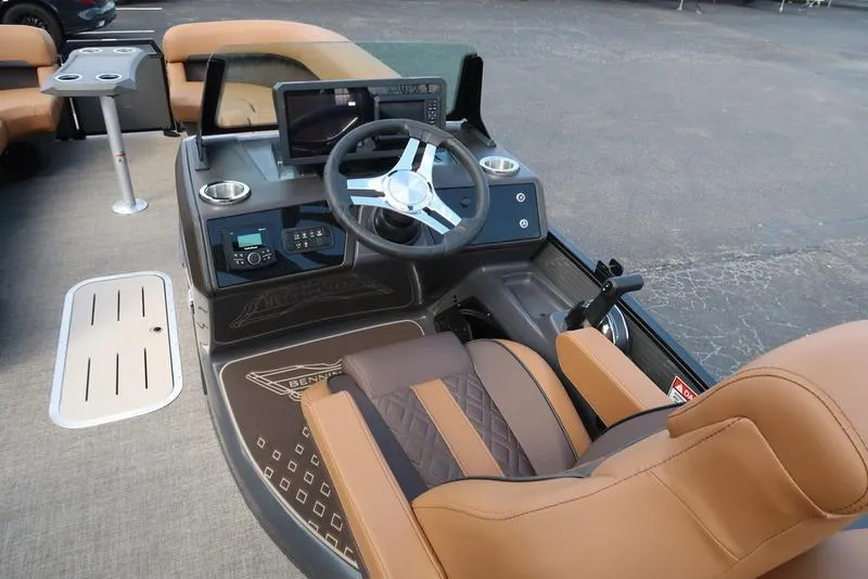 Slide: The Image of 2025 Bennington M Quad Bench 24 MFB boat interior with steering wheel and seating. - 13