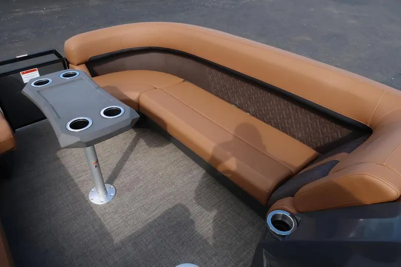 Slide: The Image of 2025 Bennington M Quad Bench 24 MFB with tan seating and cupholder table. - 17