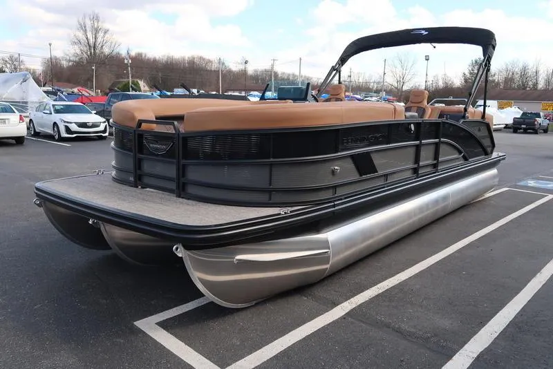 Slide: The Image of 2025 Bennington M Quad Bench 24 MFB pontoon boat in parking lot, side view. - 3