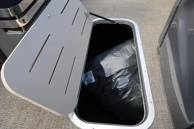Slide: The Image of Open storage compartment in 2025 Bennington M Quad Bench 24 MFB boat. - 8