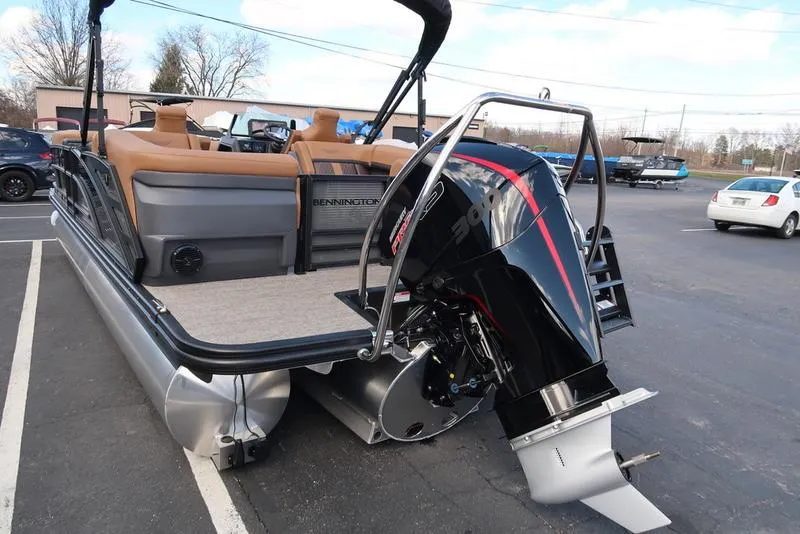 Slide: The Image of 2025 Bennington M Quad Bench 24 MFB pontoon boat with powerful outboard motor. - 9
