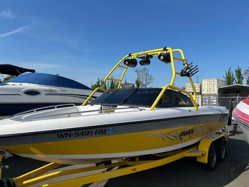 Slide: The Image of 2002 Malibu Wakesetter 21 XTi boat in yellow with wakeboard tower and trailer. - 0