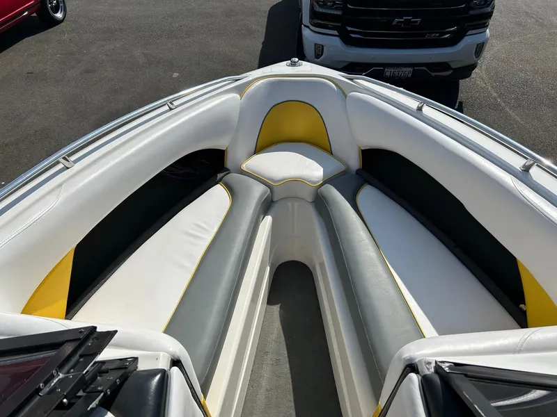 Slide: The Image of 2002 Malibu Wakesetter 21 XTi boat interior with white, gray, and yellow seating. - 10
