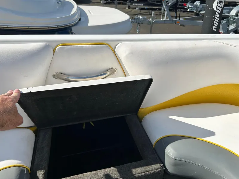 Slide: The Image of 2002 Malibu Wakesetter 21 XTi boat interior with open storage compartment. - 12