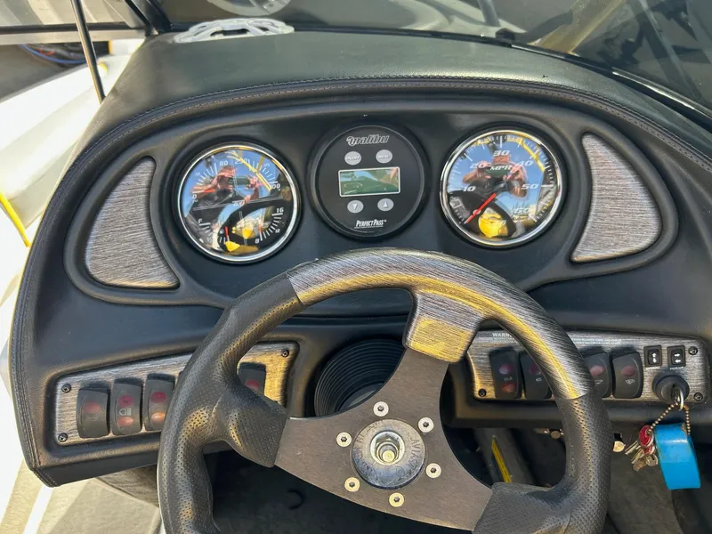 Slide: The Image of Dashboard of a 2002 Malibu Wakesetter 21 XTi boat with gauges and steering wheel. - 6
