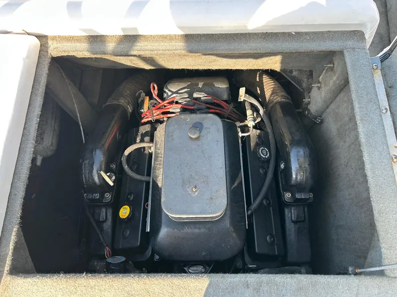 Slide: The Image of 2002 Malibu Wakesetter 21 XTi engine compartment with visible components and wiring. - 8