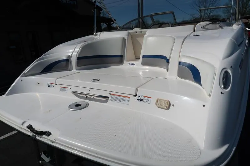 Slide: The Image of 2004 Yamaha Boats SX 230, white and blue, rear view, spacious seating, sleek design. - 10