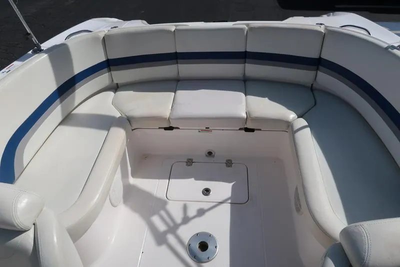 Slide: The Image of 2004 Yamaha Boats SX 230 interior seating with white and blue upholstery. - 11
