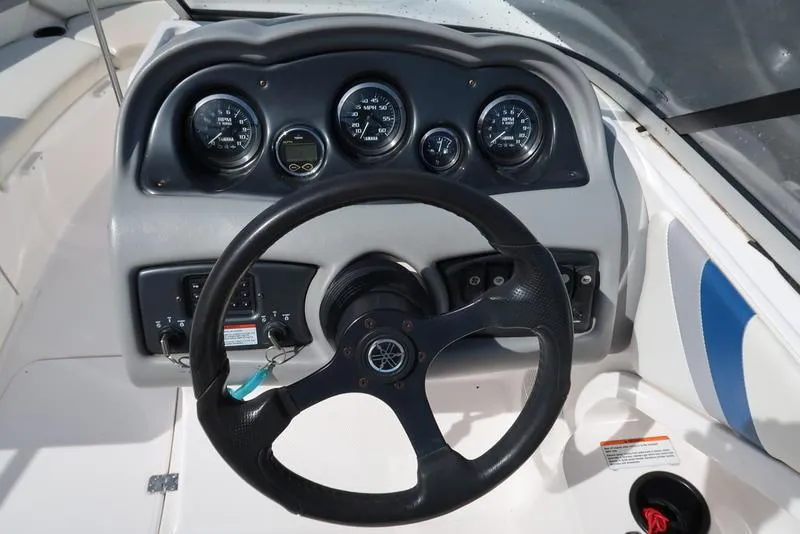 Slide: The Image of 2004 Yamaha Boats SX 230 dashboard with steering wheel and gauges. - 15