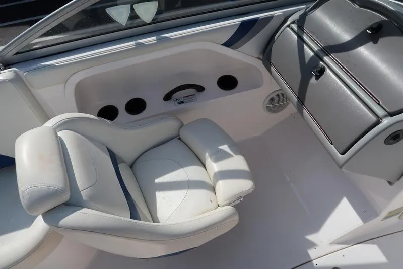 Slide: The Image of 2004 Yamaha Boats SX 230 interior with white seating and dashboard. - 17