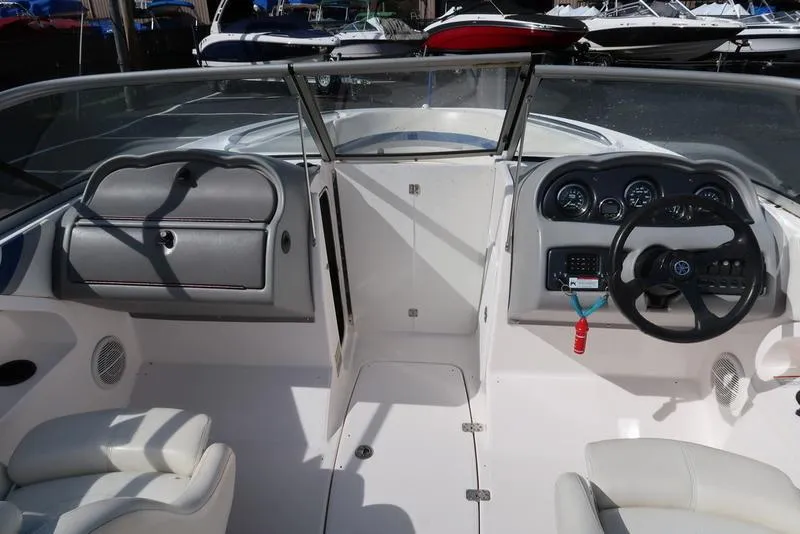 Slide: The Image of 2004 Yamaha Boats SX 230 cockpit with steering wheel and dashboard controls. - 19