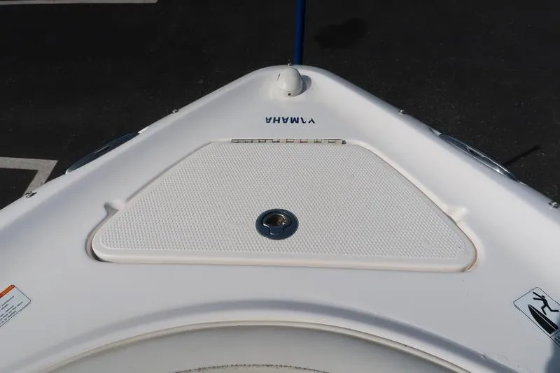 Slide: The Image of 2004 Yamaha Boats SX 230 bow with storage compartment, white exterior. - 23