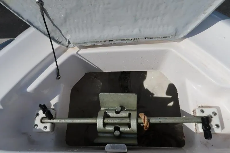 Slide: The Image of Open storage compartment in 2004 Yamaha SX 230 boat, showing interior mechanism. - 3