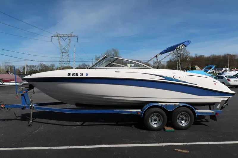 Slide: The Image of 2004 Yamaha Boats SX 230 on trailer, parked outdoors, clear sky background. - 7