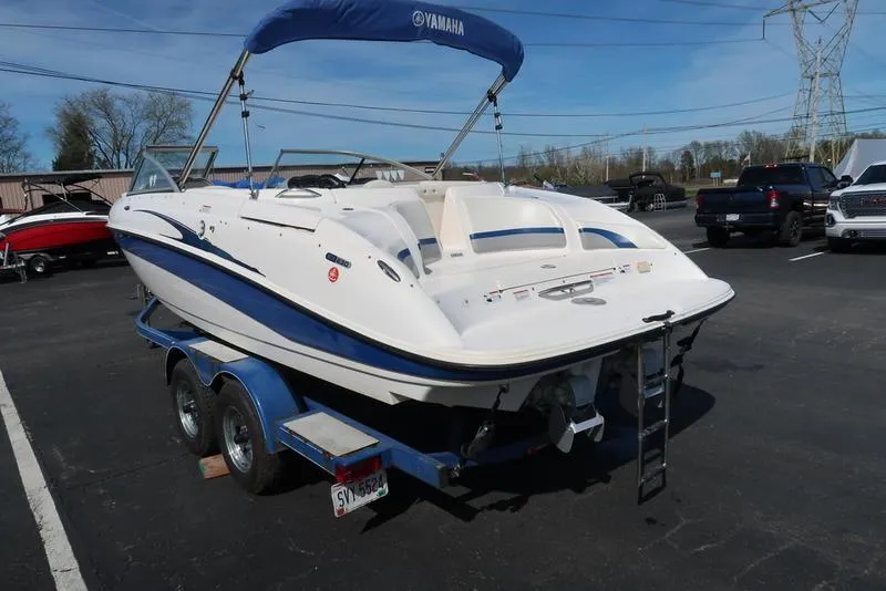 Slide: The Image of 2004 Yamaha Boats SX 230 on trailer, parked outdoors with blue canopy. - 9