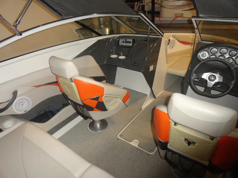 Slide: The Image of Interior of 2005 Campion Chase 550I BR boat with orange and white seating. - 11