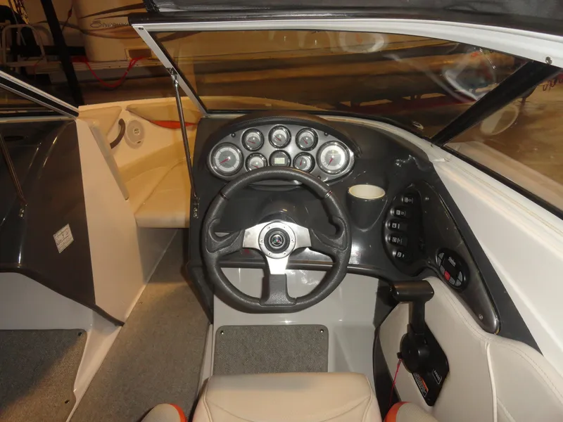 Slide: The Image of 2005 Campion Chase 550I BR boat dashboard with steering wheel and instrument panel. - 7