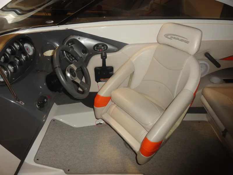 Slide: The Image of 2005 Campion Chase 550I BR boat interior with steering wheel and cushioned seat. - 9