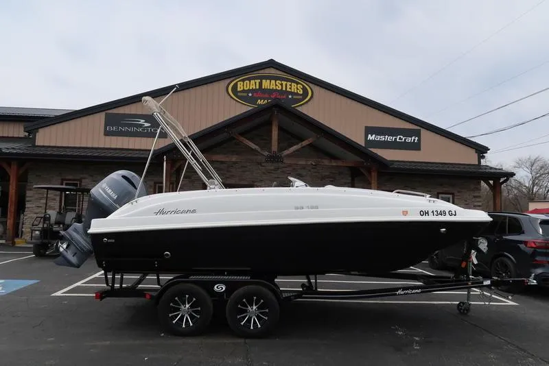 The Image of 2023 Hurricane SunDeck Sport 188 OB boat on trailer outside dealership. - 1