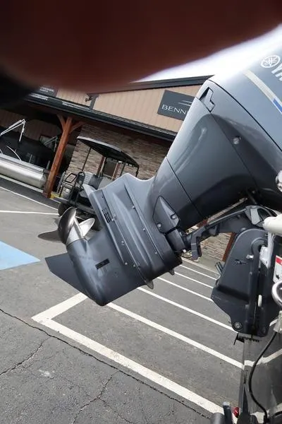 Slide: The Image of 2023 Hurricane SunDeck Sport 188 OB outboard motor in a parking lot. - 11