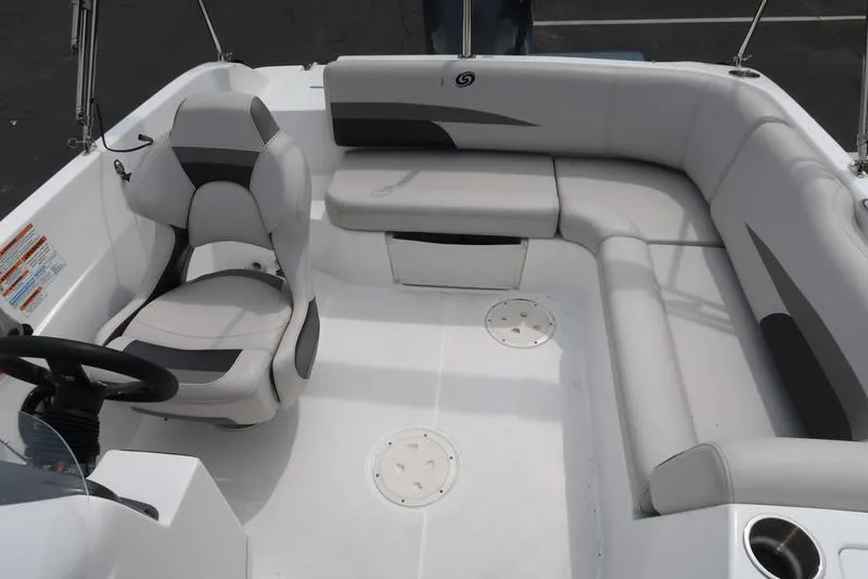 Slide: The Image of 2023 Hurricane SunDeck Sport 188 OB boat interior with white seating and steering console. - 14