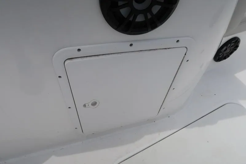Slide: The Image of 2023 Hurricane SunDeck Sport 188 OB boat storage compartment with speaker detail. - 18