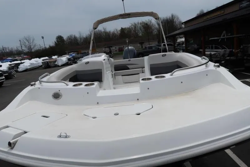 Slide: The Image of 2023 Hurricane SunDeck Sport 188 OB boat, white exterior, docked outdoors. - 5