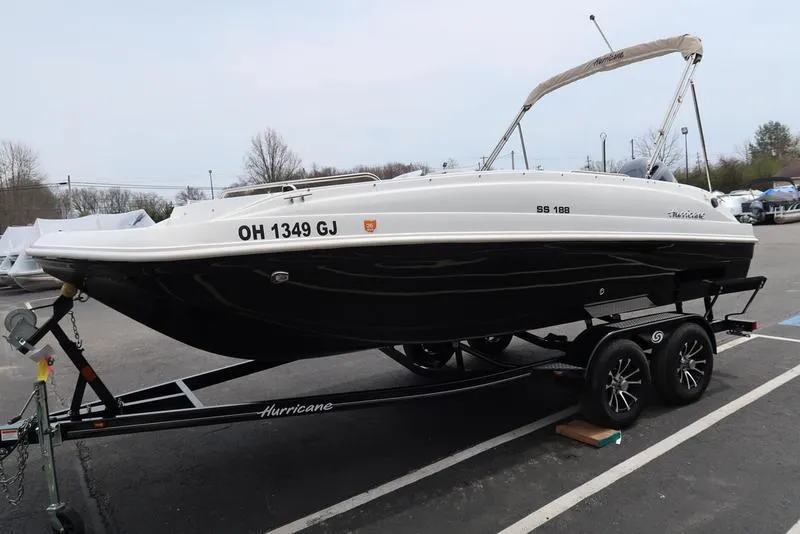 Slide: The Image of 2023 Hurricane SunDeck Sport 188 OB boat on trailer in parking lot. - 6