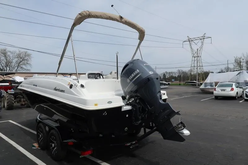 Slide: The Image of 2023 Hurricane SunDeck Sport 188 OB boat with Yamaha outboard motor in parking lot. - 8