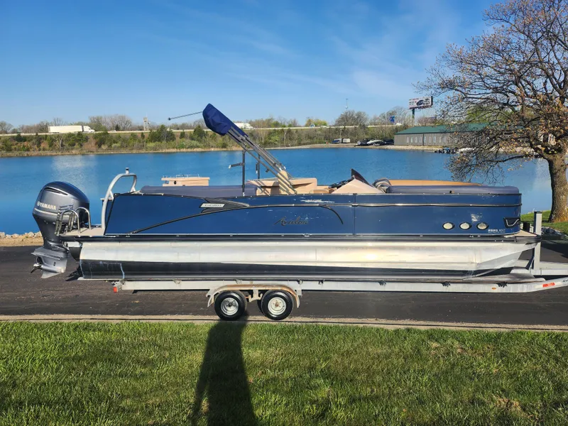 Slide: The Image of 2021 Avalon Catalina Platinum Entertainer Funship pontoon boat on trailer by a lake. - 12