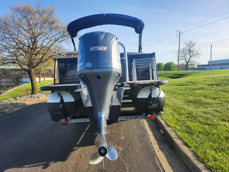 Slide: The Image of 2021 Avalon Catalina Platinum Entertainer Funship boat with powerful engine, parked on a sunny day. - 2