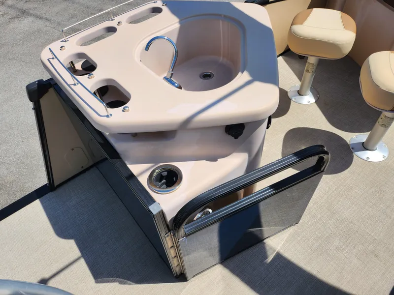 Slide: The Image of 2021 Avalon Catalina Platinum Entertainer Funship boat interior with sink and seating area. - 21