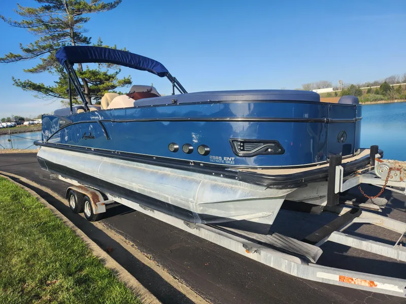 Slide: The Image of 2021 Avalon Catalina Platinum Entertainer Funship on trailer by a lake. - 9