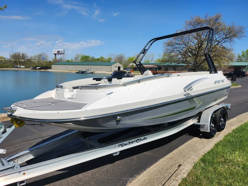 Slide: The Image of 2021 Starcraft Star Step 221 E I/O boat on trailer by a lake. - 10