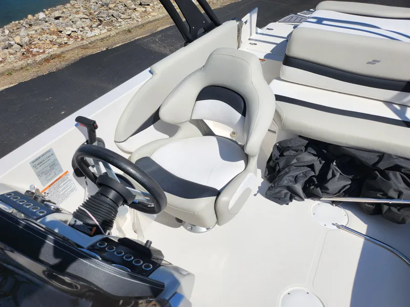 Slide: The Image of 2021 Starcraft Star Step 221 E I/O boat interior with steering wheel and seating. - 13