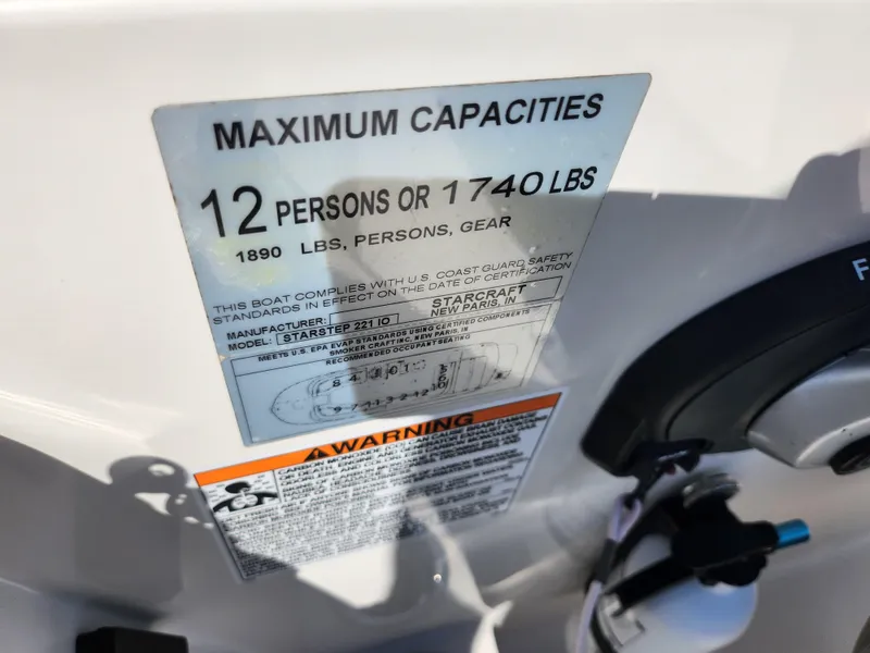 Slide: The Image of 2021 Starcraft Star Step 221 E I/O capacity label, 12 persons or 1740 lbs limit. - 14