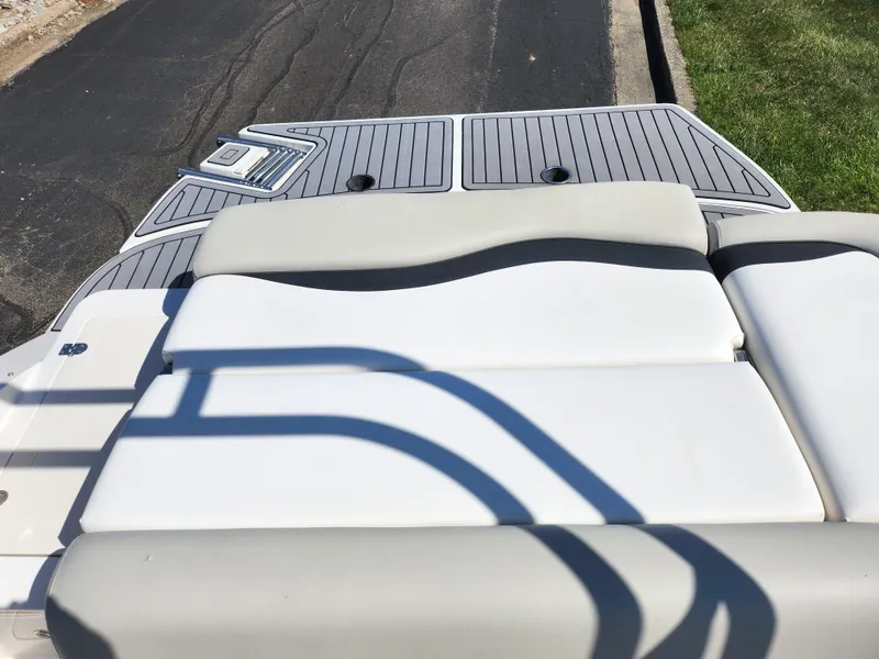 Slide: The Image of 2021 Starcraft Star Step 221 E I/O boat with cushioned seating and deck view. - 16