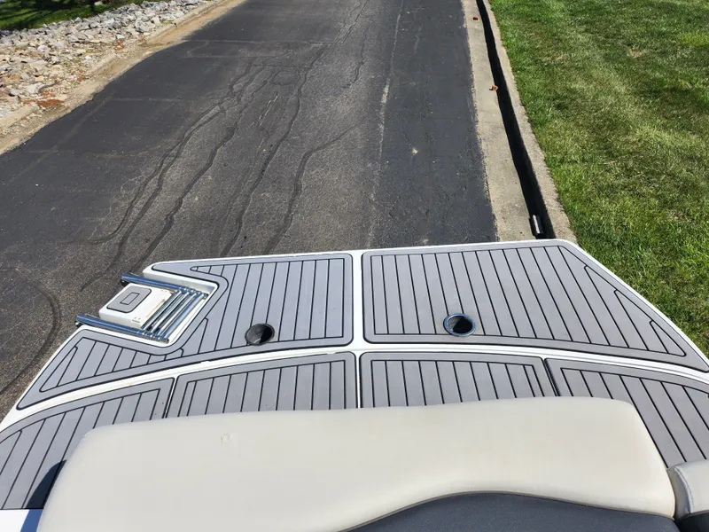 Slide: The Image of 2021 Starcraft Star Step 221 E I/O boat deck with sleek design and ladder. - 17