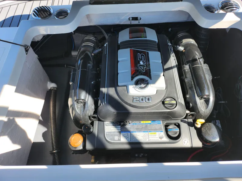 Slide: The Image of Engine compartment of 2021 Starcraft Star Step 221 E I/O boat, featuring a 4.5L 200 HP engine. - 18