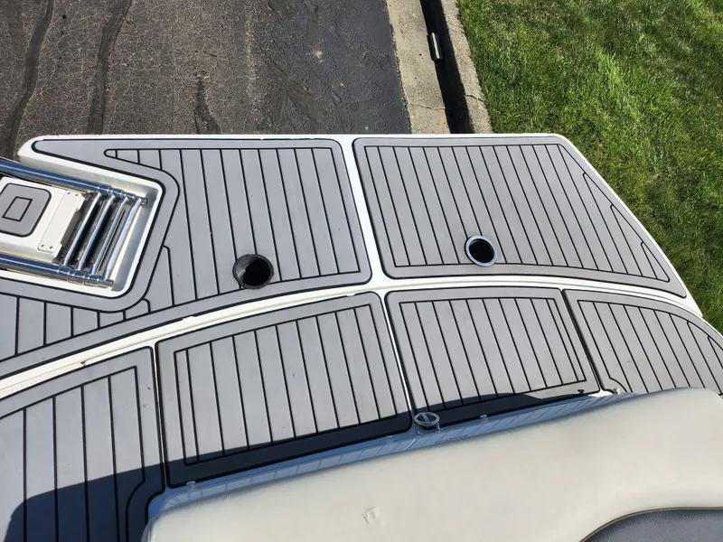 Slide: The Image of 2021 Starcraft Star Step 221 E I/O boat deck with sleek gray design. - 20