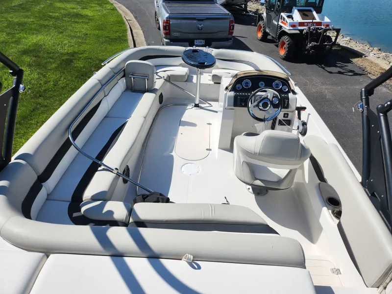 Slide: The Image of 2021 Starcraft Star Step 221 E I/O boat interior with seating and steering console. - 22