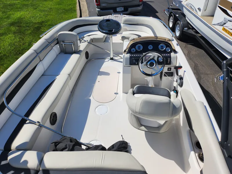 Slide: The Image of 2021 Starcraft Star Step 221 E I/O boat interior with seating and steering console. - 23