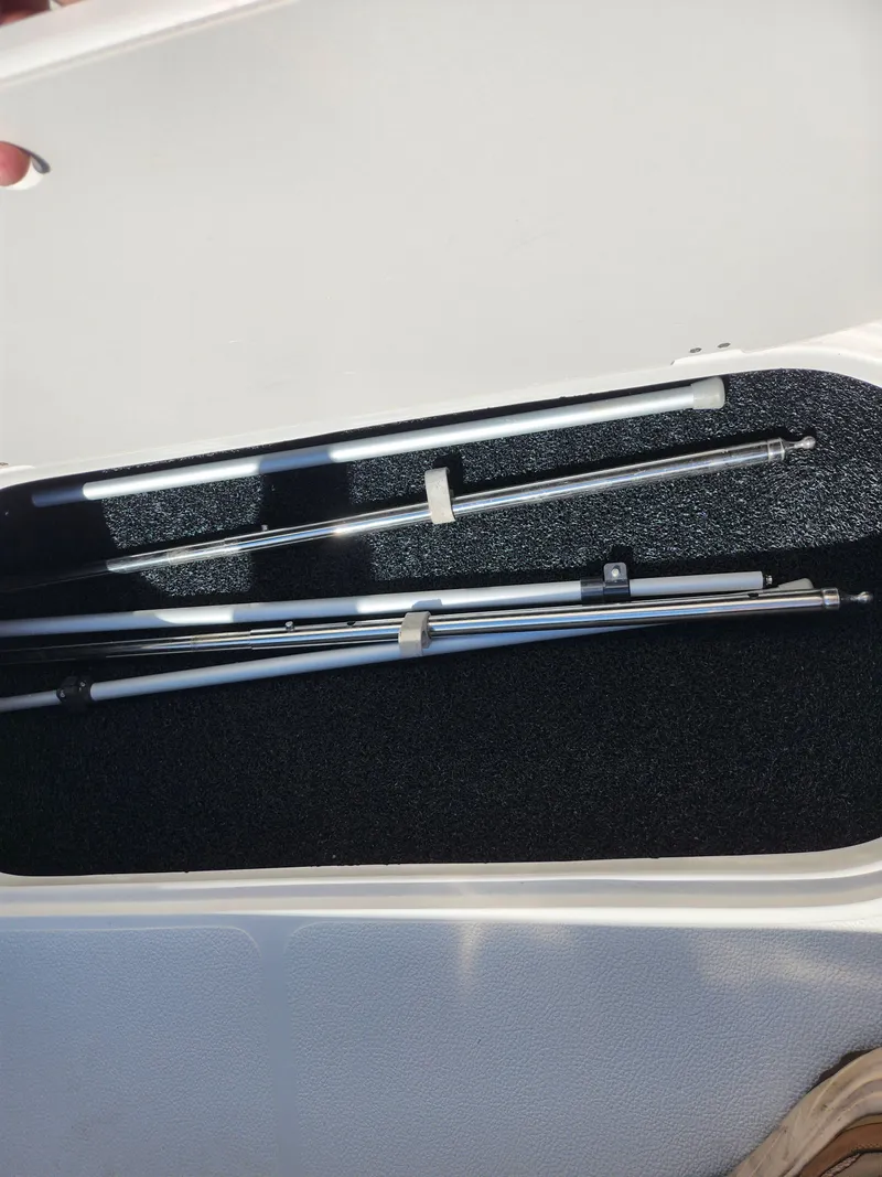 Slide: The Image of Storage compartment of 2021 Starcraft Star Step 221 E I/O boat with metal rods. - 25