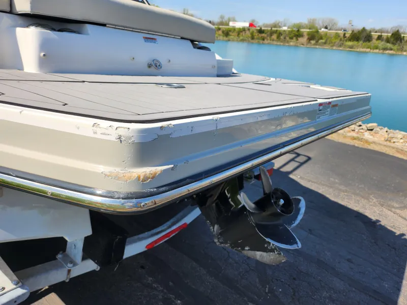 Slide: The Image of 2021 Starcraft Star Step 221 E I/O boat with visible wear on the rear platform. - 3