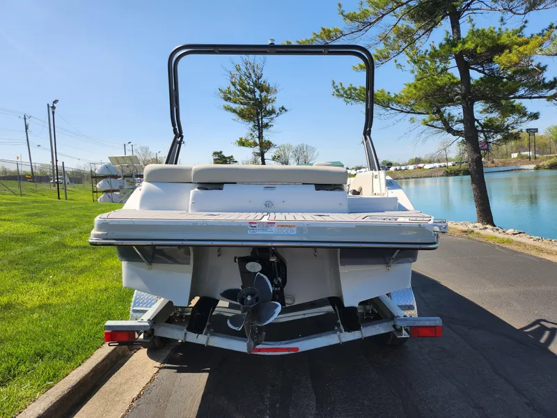 Slide: The Image of 2021 Starcraft Star Step 221 E I/O boat, rear view, parked near a lake. - 4