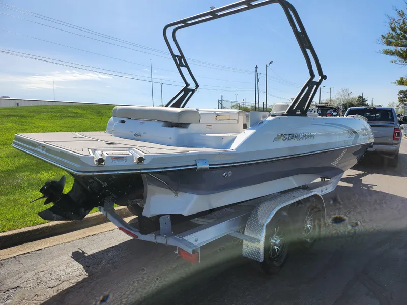 Slide: The Image of 2021 Starcraft Star Step 221 E I/O boat on trailer, parked outdoors. - 5