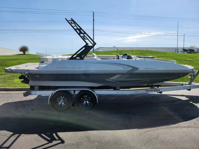 Slide: The Image of 2021 Starcraft Star Step 221 E I/O boat on trailer, parked outdoors. - 6