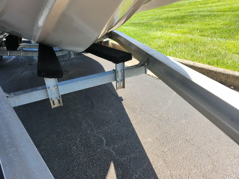 Slide: The Image of Trailer for 2021 Starcraft Star Step 221 E I/O boat on pavement. - 9